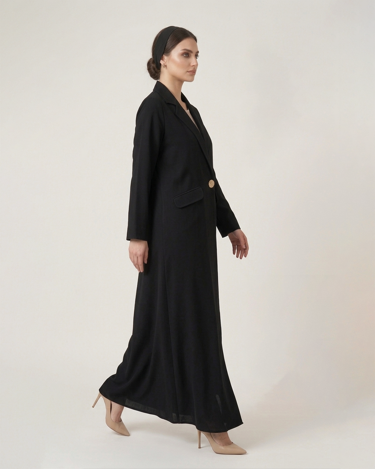 Woman wearing a black suit with a white background