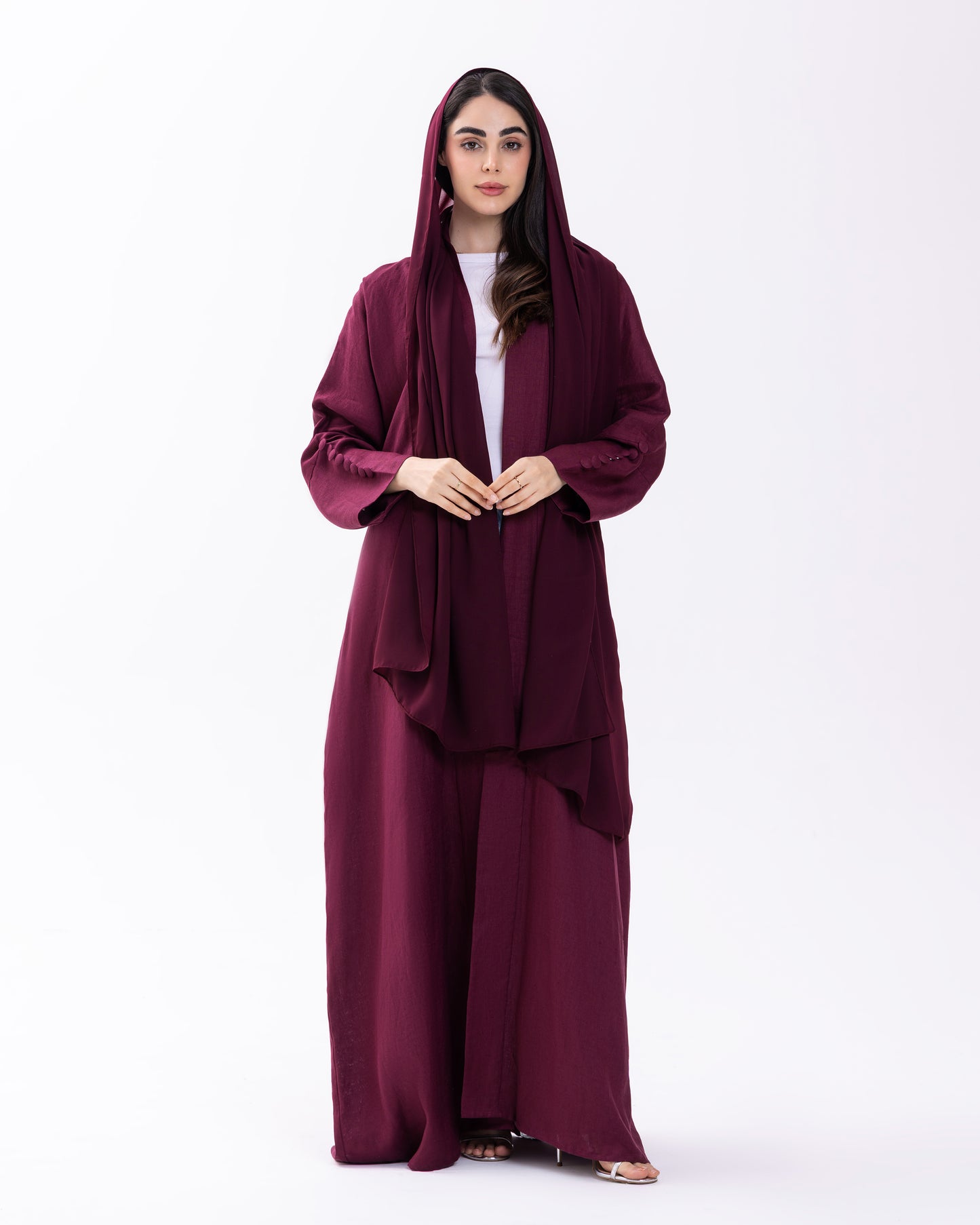Woman wearing a burgundy abaya on a white background