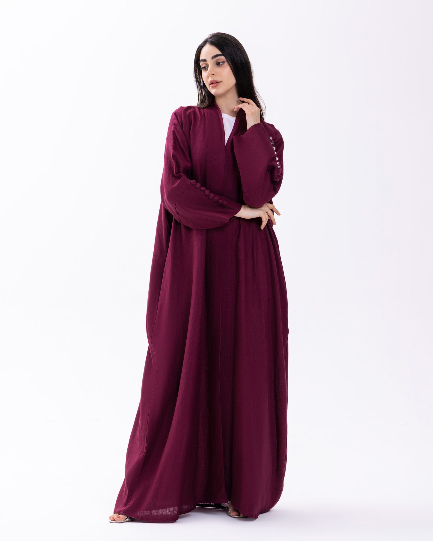 Woman wearing a burgundy abaya on a white background