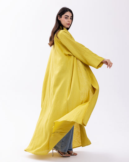 Woman wearing a long yellow dress on a white background