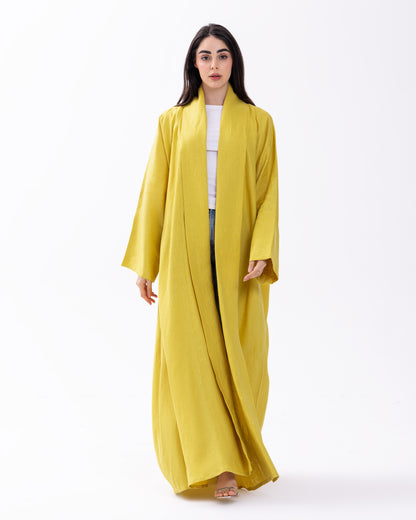 Woman wearing a yellow abaya on a white background