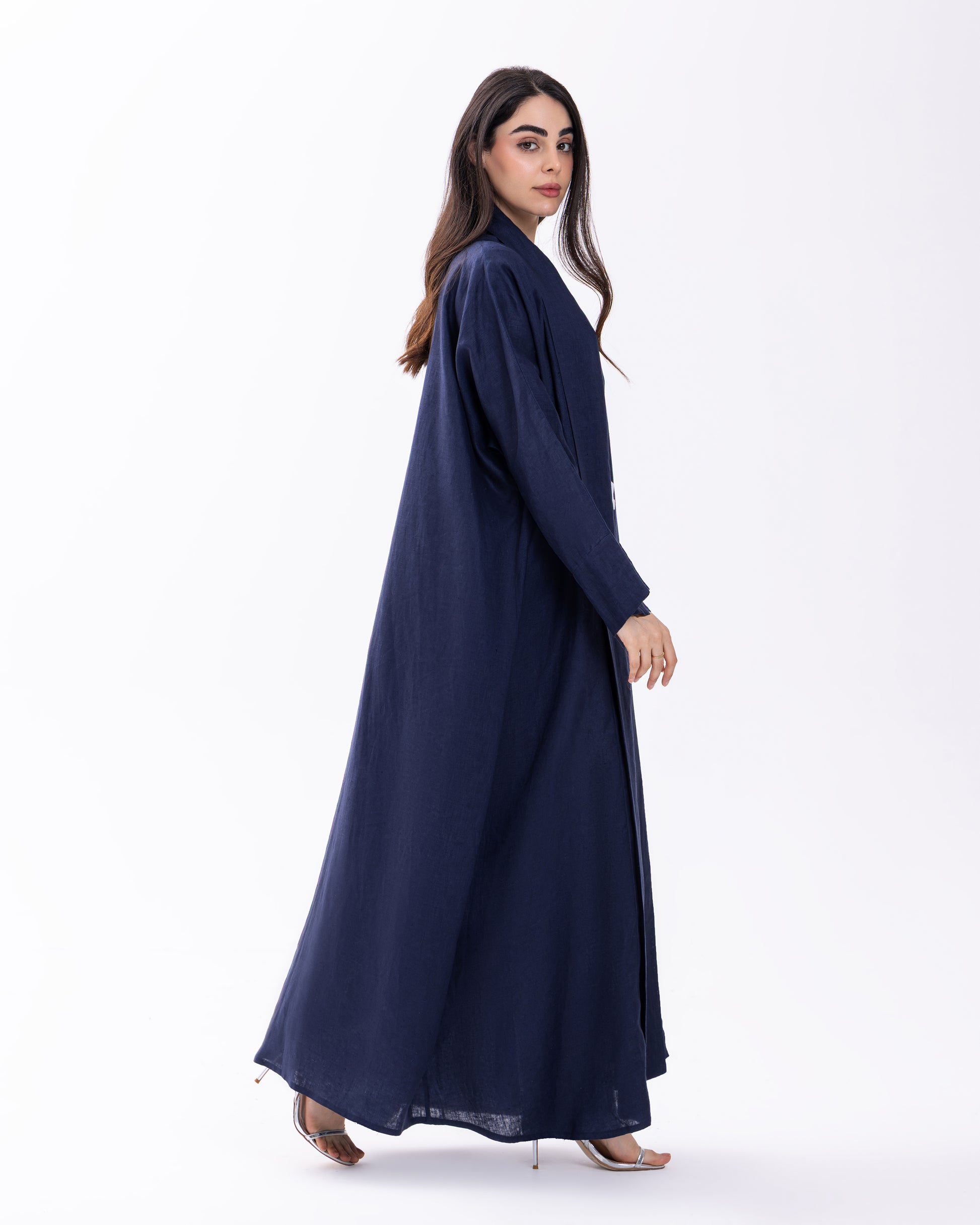 Woman wearing a navy blue abaya on a white background