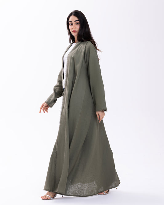 Woman wearing a long green dress on a white background