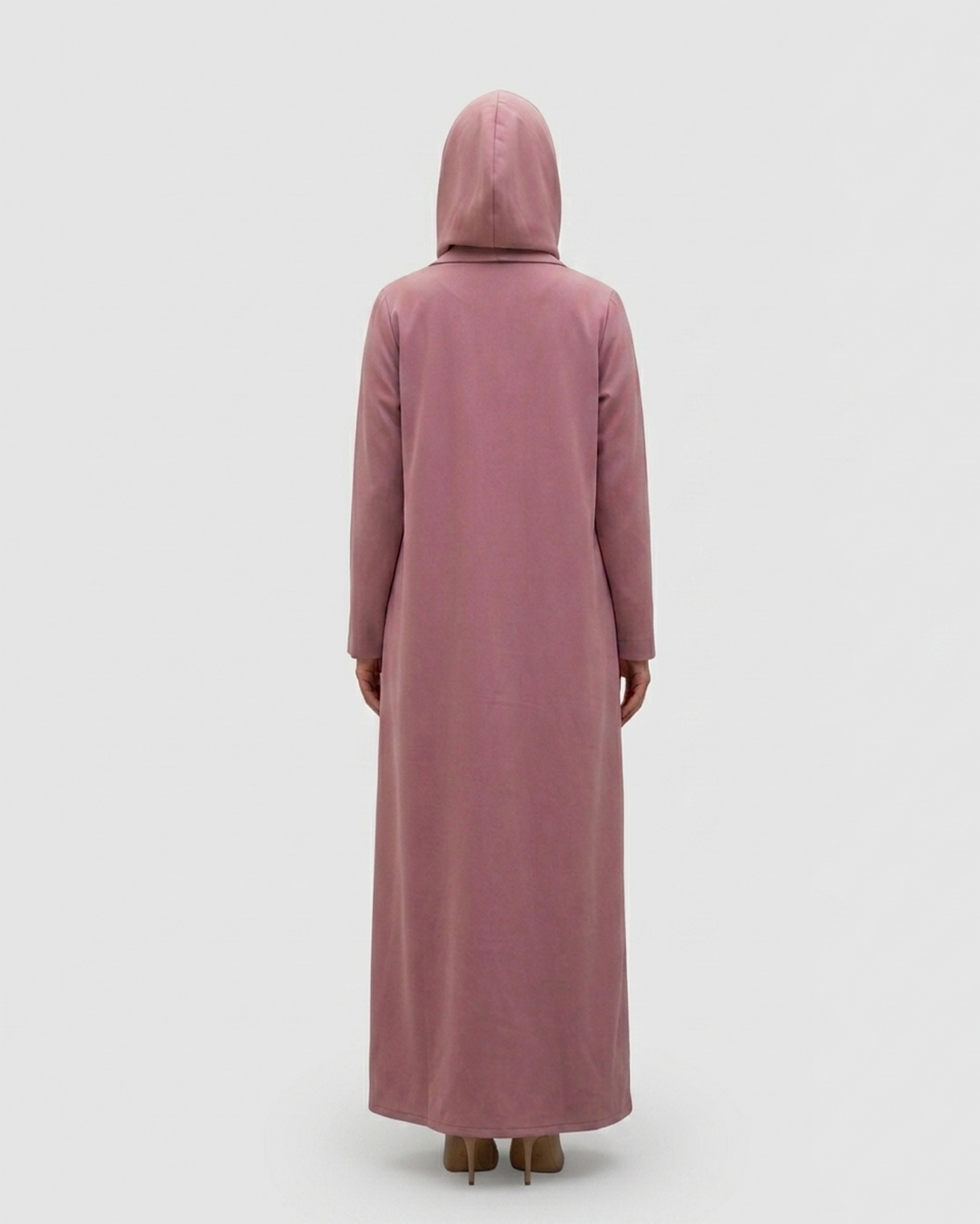 Person wearing a long, light pink dress with a hood on a white background