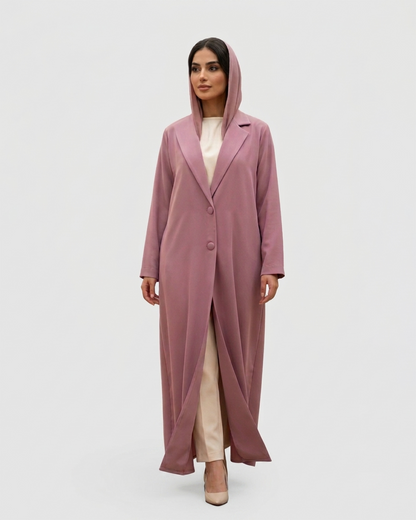 Woman wearing a long pink coat on a white background