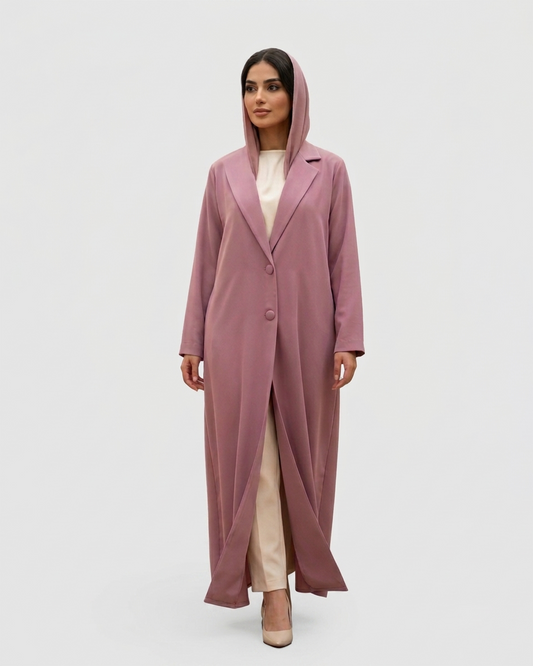Woman wearing a long pink coat on a white background
