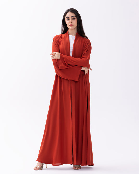 Woman wearing a red dress with a matching jacket on a white background