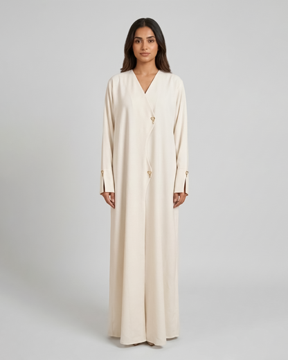 Woman wearing a long beige dress on a gray background